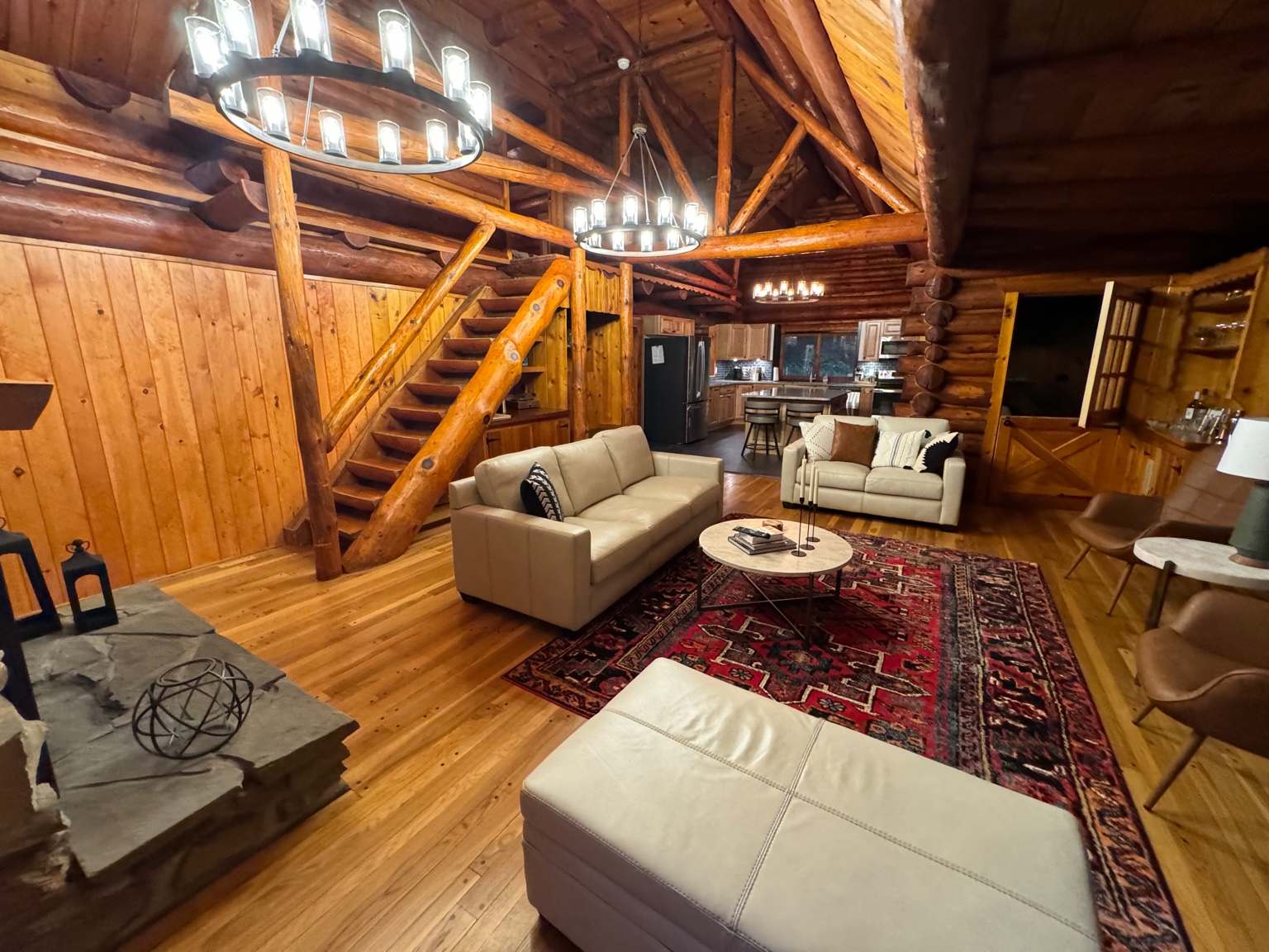 Warm log‑cabin living room with fireplace (hero)